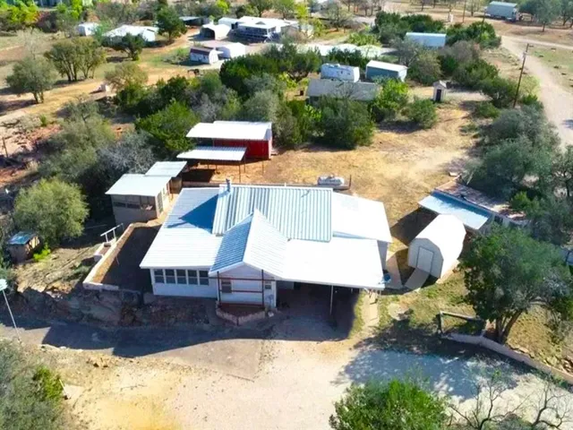 an aerial view of a house with yard swimming pool and outdoor seating