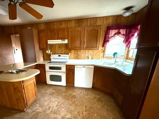 a kitchen with a stove window and sink