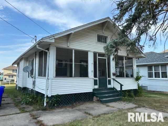 a view of house with backyard and outdoor seating