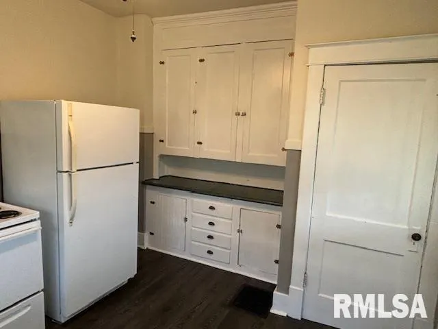 a white refrigerator freezer sitting in a kitchen