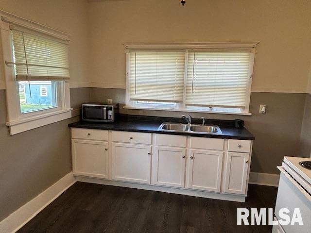 712 Roosevelt Avenue Kewanee, IL 61443 - Photo 14 of 21 a kitchen with stainless steel appliances granite countertop a sink a stove a microwave cabinets and a window