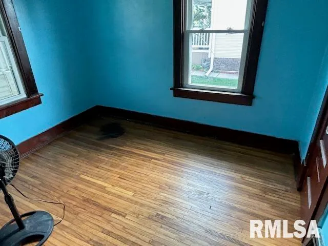 a view of a room with wooden floor and a window