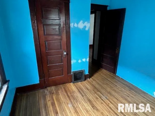 a bedroom with a bed and a mirror