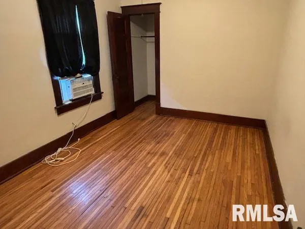 a view of a room with wooden floor