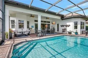 a view of swimming pool with outdoor seating