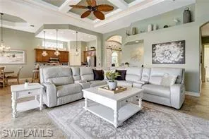 a living room with furniture a ceiling fan and a rug