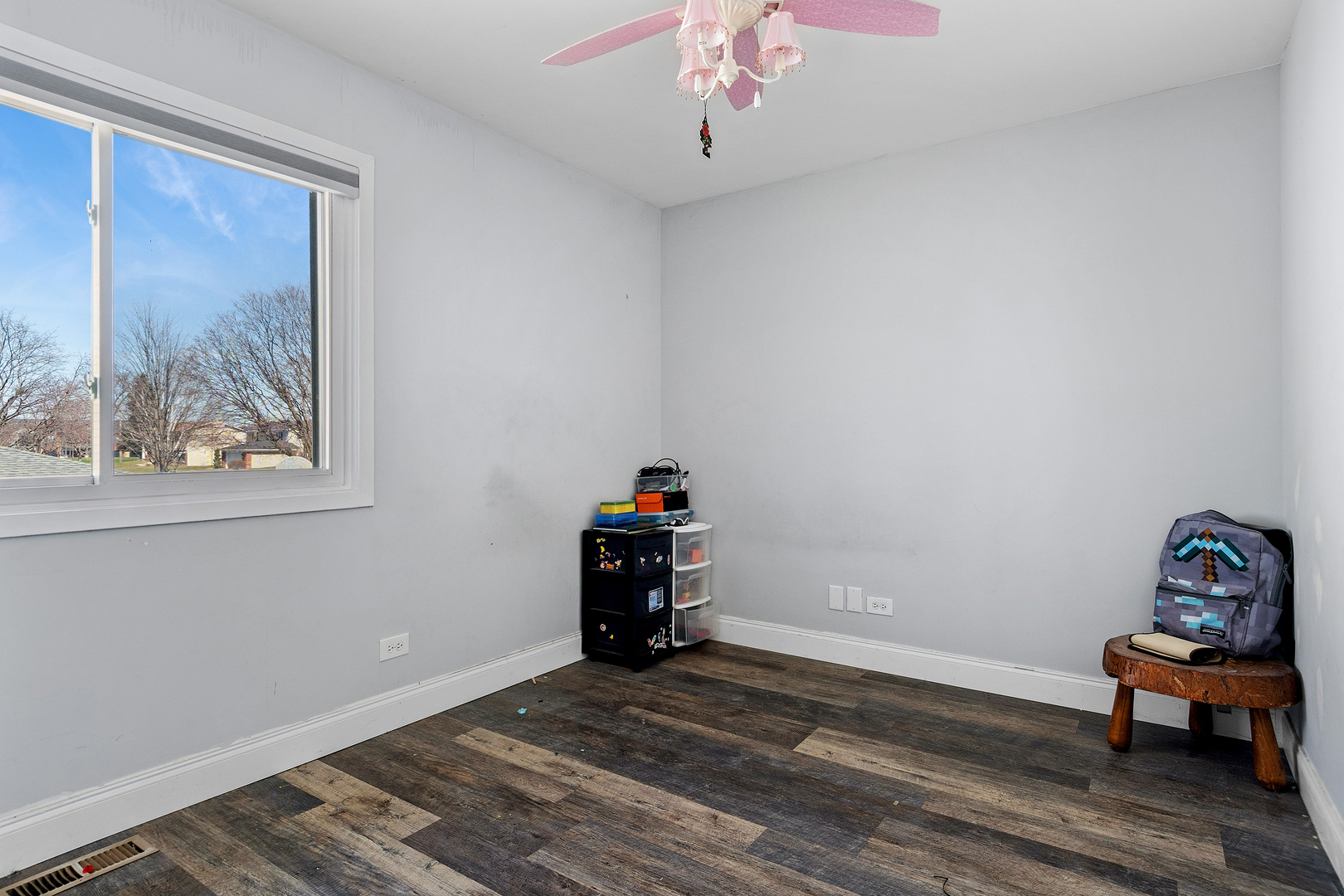 313 Thistle Drive Bolingbrook, IL 60490 - Photo 11 of 23 a view of a room with wooden floor and a window