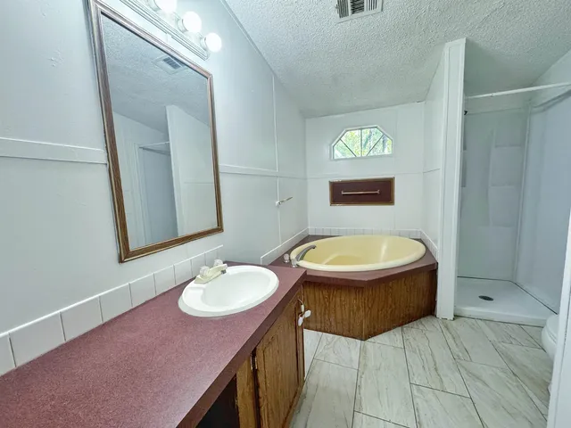a bathroom with a sink toilet a mirror and vanity