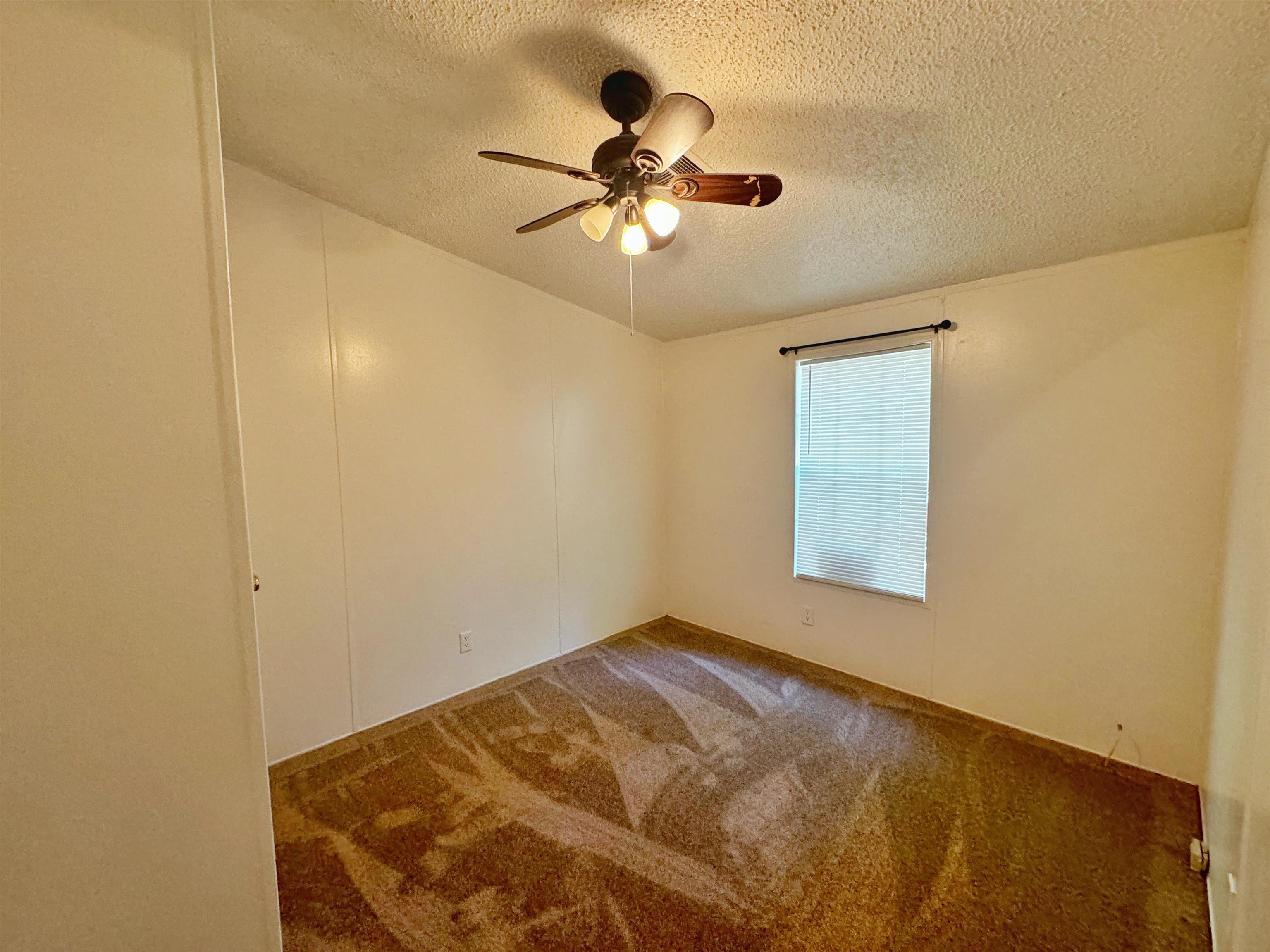 5872 Pine Creek Drive St. Augustine, FL 32092 - Photo 15 of 26 a view of a room with a ceiling fan and a window