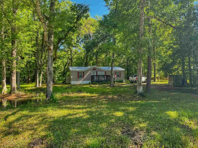 a backyard of a house with lots of green space