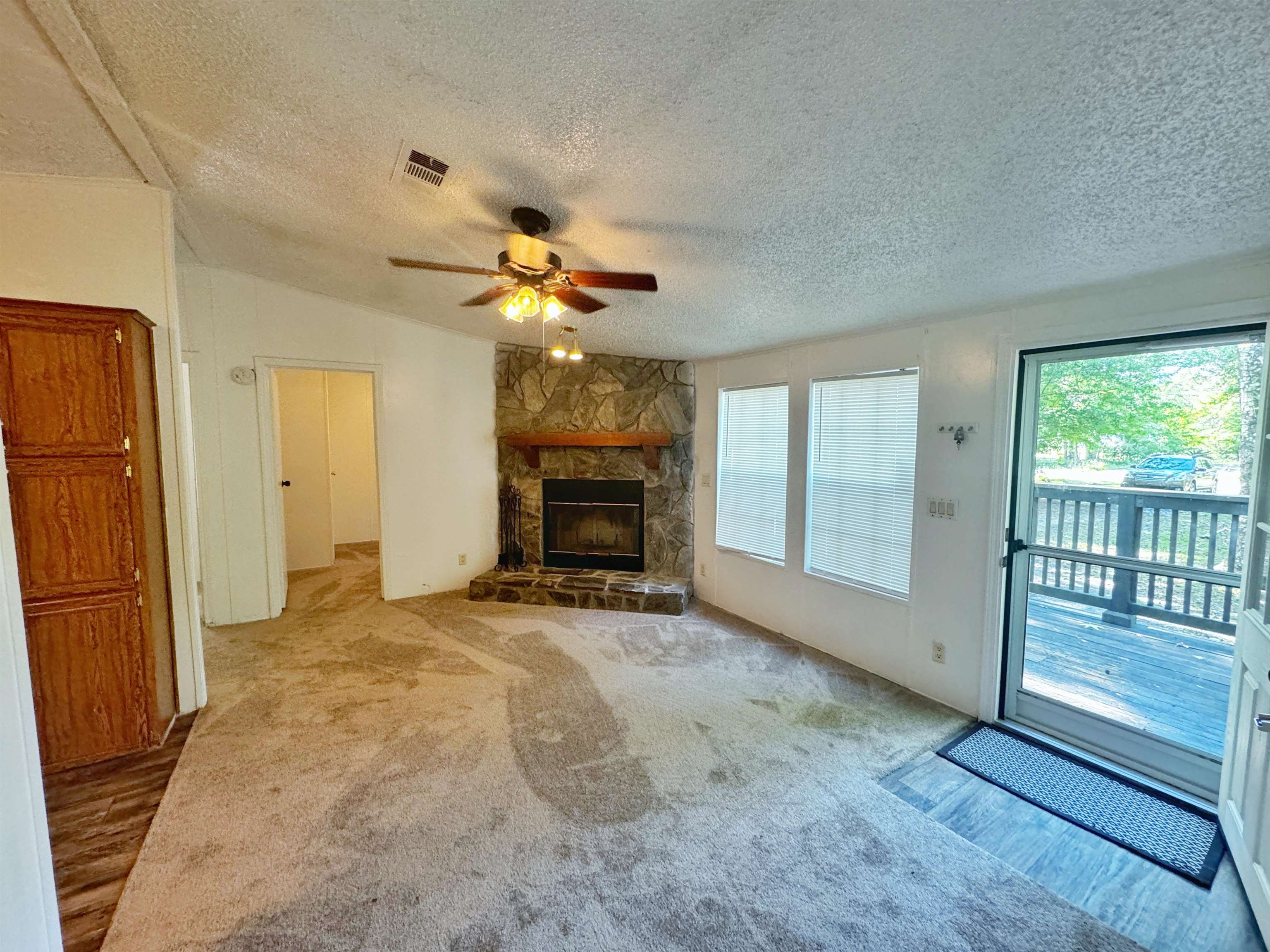 5872 Pine Creek Drive St. Augustine, FL 32092 - Photo 3 of 26 an empty room with fireplace fan and windows