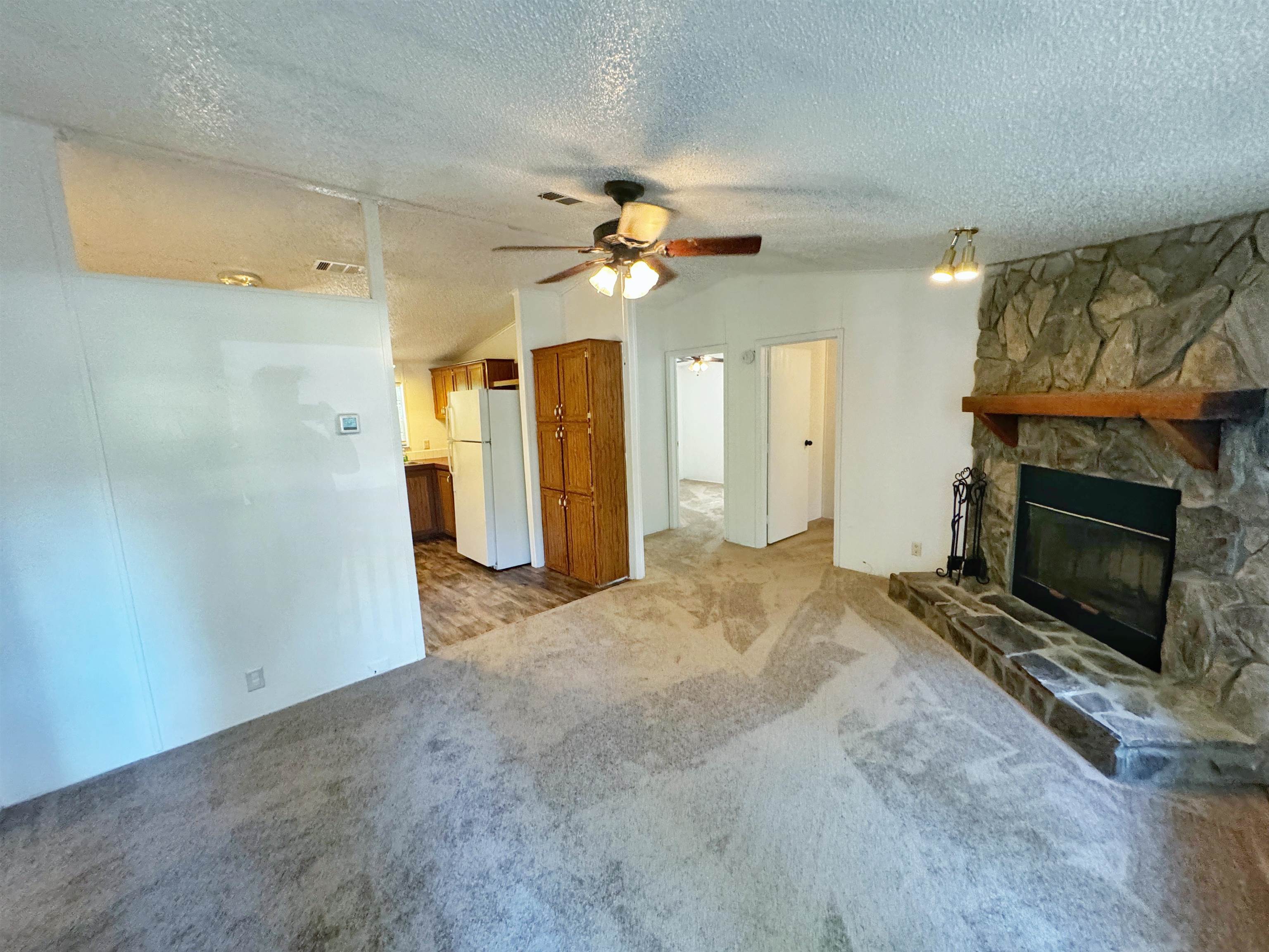 5872 Pine Creek Drive St. Augustine, FL 32092 - Photo 4 of 26 a view of a livingroom with a fireplace and ceiling fan
