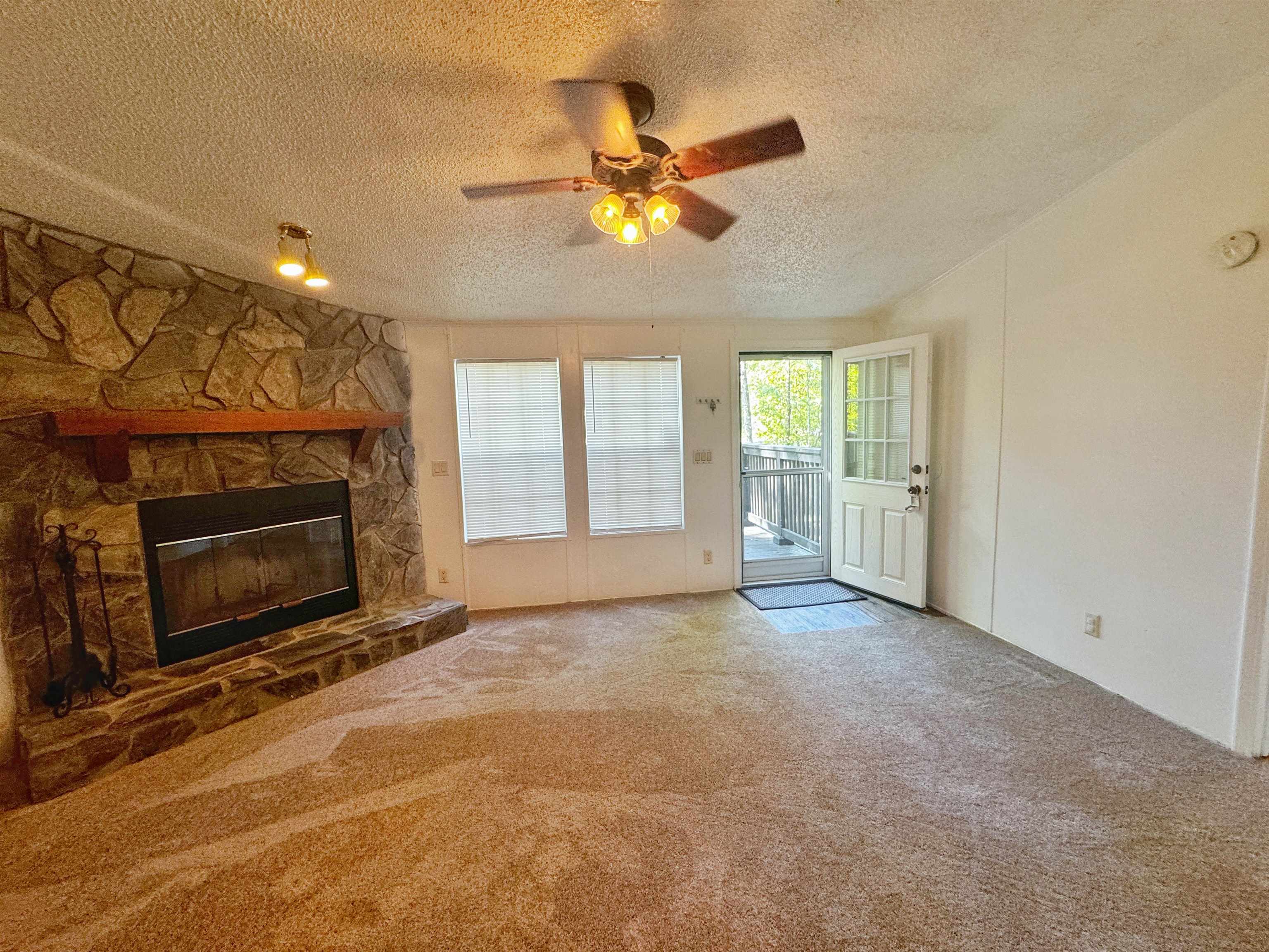 5872 Pine Creek Drive St. Augustine, FL 32092 - Photo 6 of 26 a view of an empty room with a fireplace and a window