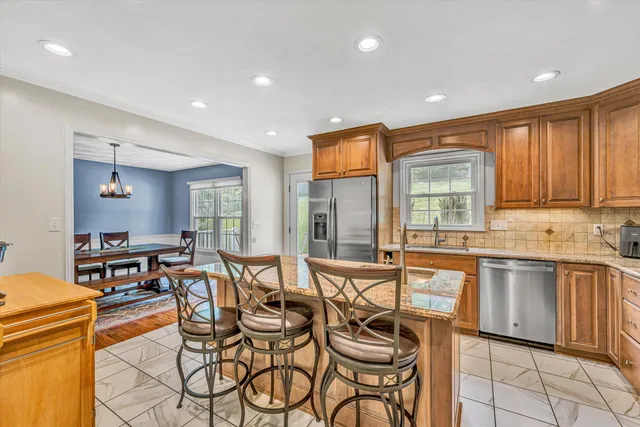 a dining hall with stainless steel appliances a table and chairs in it