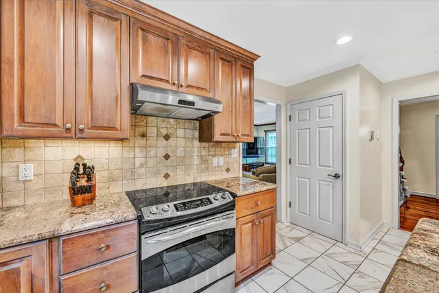 a kitchen with granite countertop cabinets and steel stainless steel appliances
