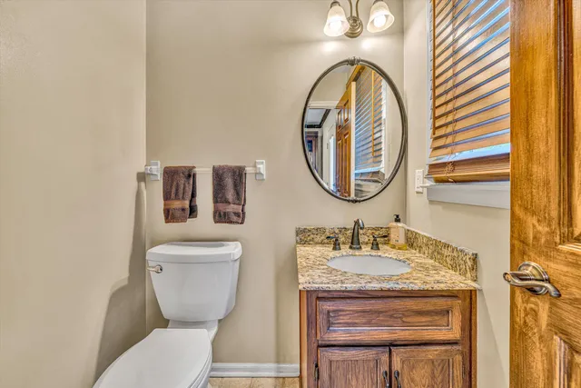 a bathroom with a toilet a sink and a mirror