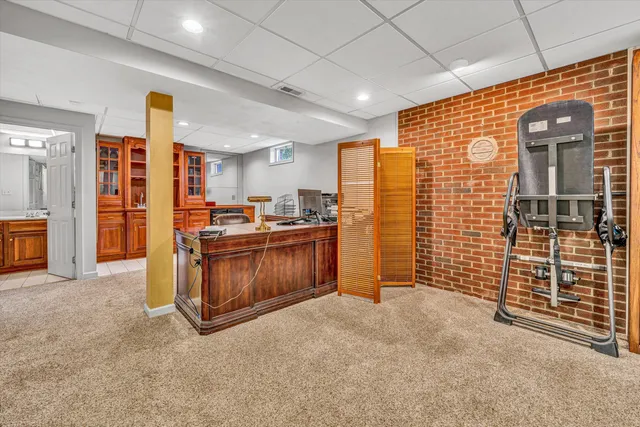 a living room with furniture a flat screen tv and kitchen view
