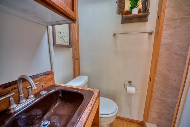 a bathroom with a toilet and a shower