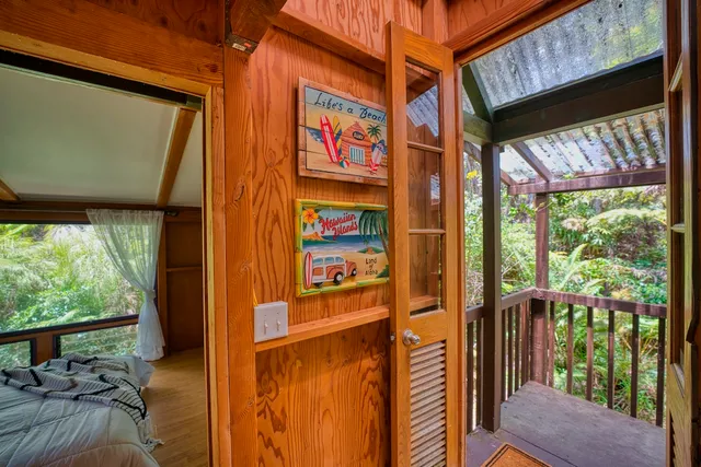 a view of a porch with furniture and wooden floor