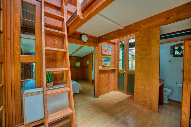 a view of an entryway with wooden floor and door