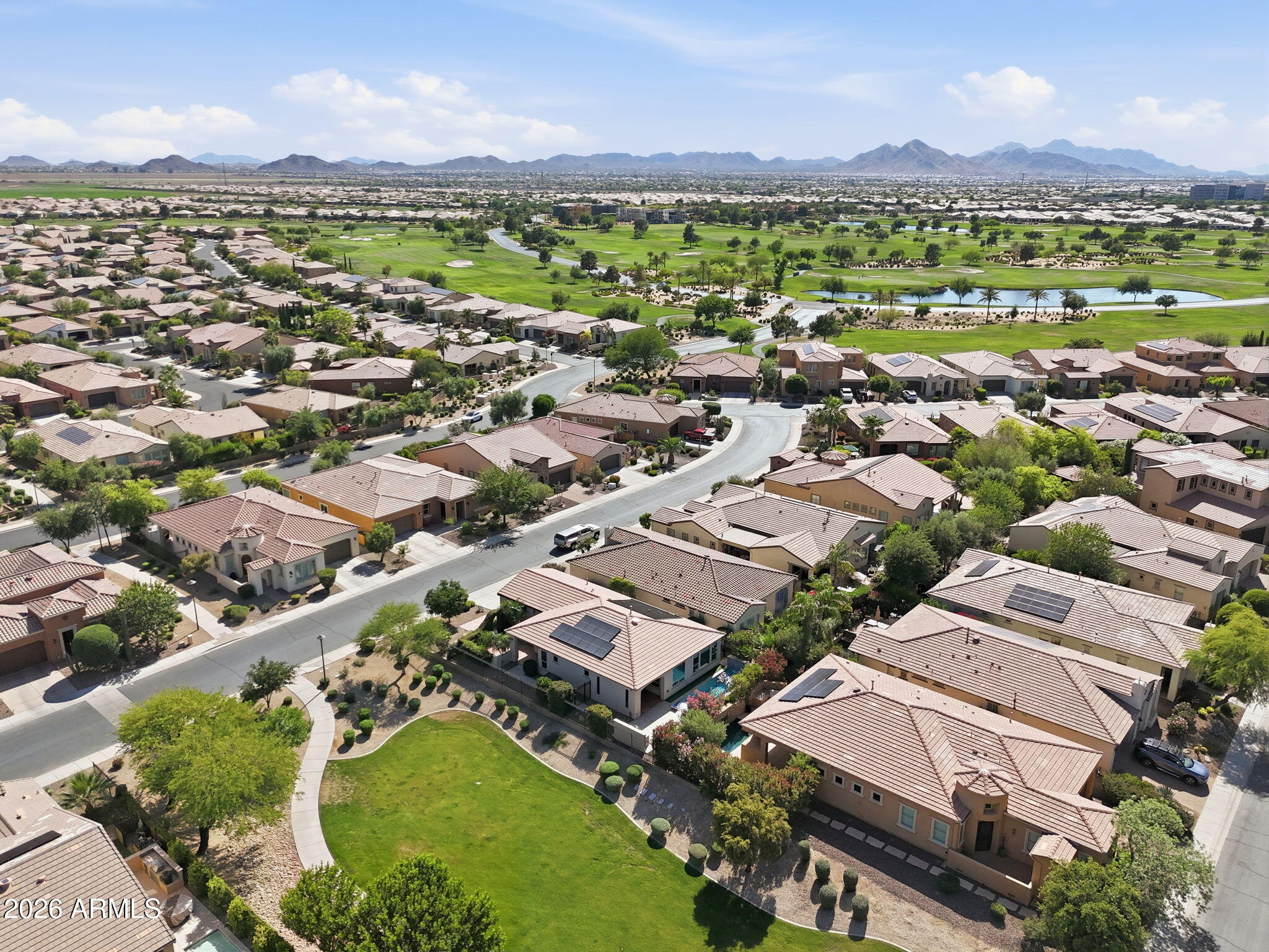 1694 East Grand Ridge Road Queen Creek, AZ 85140 - Photo 41 of 61 an aerial view of a city with lots of residential buildings and mountain view in back