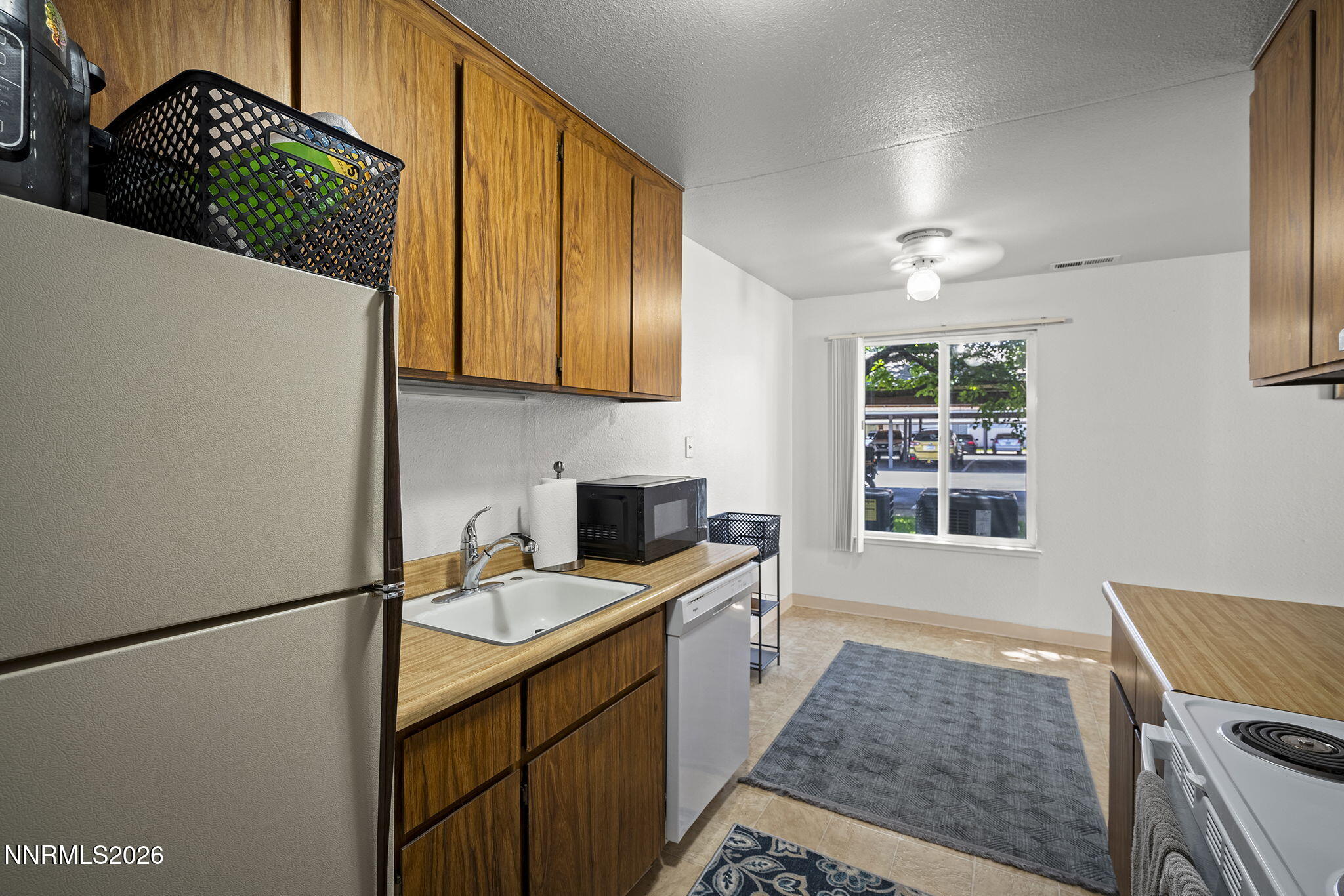 400 South Saliman Road, Unit 129 Carson City, NV 89701 - Photo 2 of 15 a kitchen with stainless steel appliances granite countertop a sink stove and refrigerator