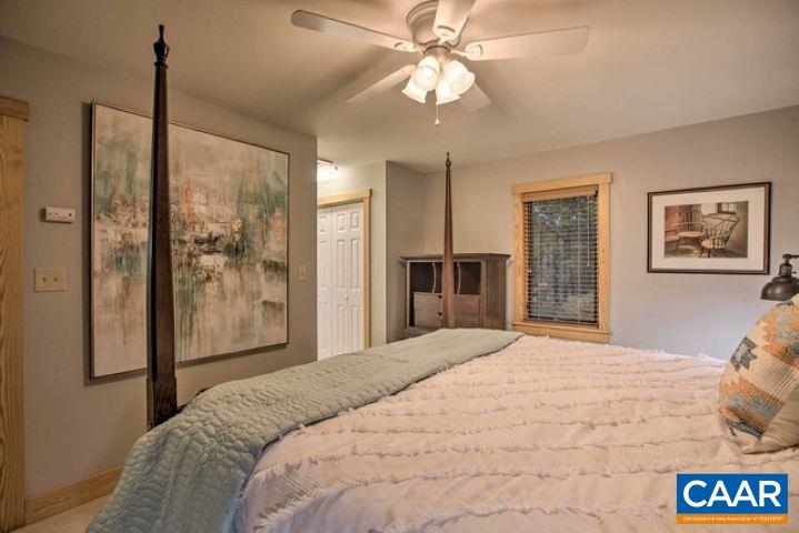 280 Fawn Ridge Drive Wintergreen, VA 22967 - Photo 15 of 23 a bedroom with a large bed and a chandelier