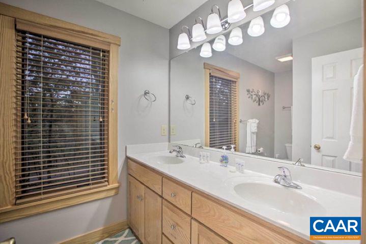 280 Fawn Ridge Drive Wintergreen, VA 22967 - Photo 17 of 23 a bathroom with a double vanity sink and a mirror