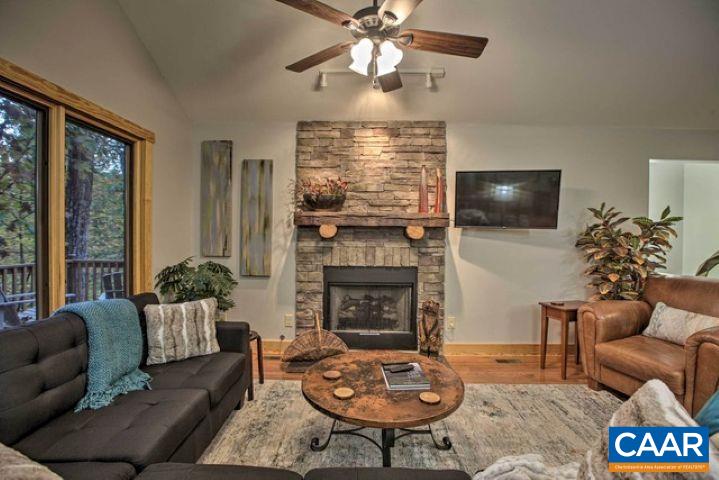 280 Fawn Ridge Drive Wintergreen, VA 22967 - Photo 4 of 23 a living room with furniture a fireplace and a flat screen tv