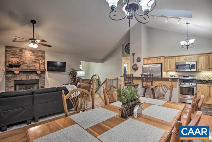 280 Fawn Ridge Drive Wintergreen, VA 22967 - Photo 6 of 23 a view of a dining room with furniture a chandelier and wooden floor