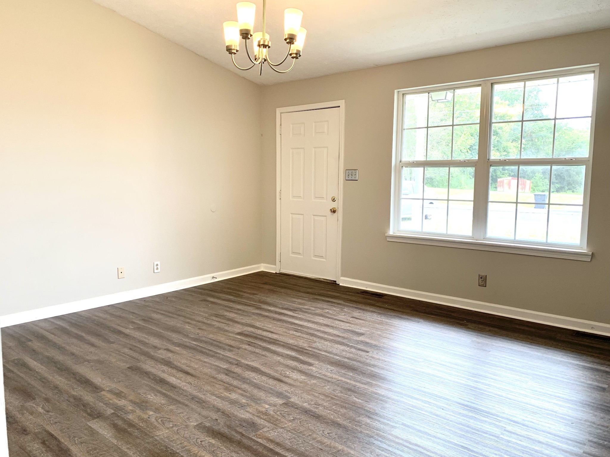 122 Grant Avenue Oak Grove, KY 42262 - Photo 2 of 14 an empty room with wooden floor and windows