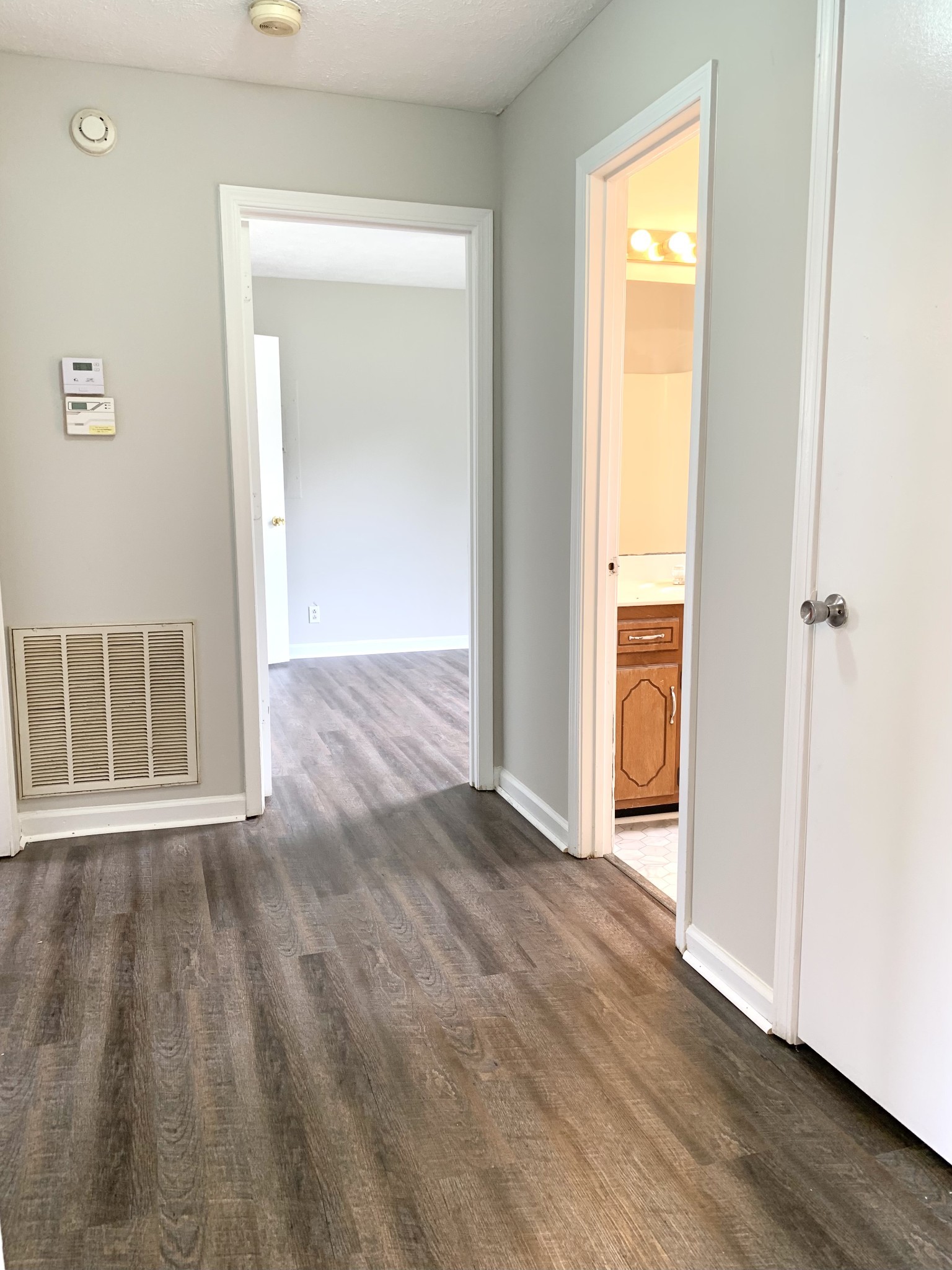 122 Grant Avenue Oak Grove, KY 42262 - Photo 8 of 14 an empty room with wooden floor and a window