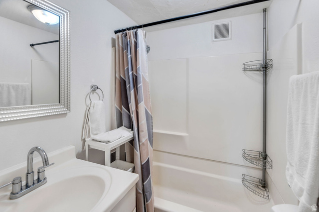 358 400 South Provo, UT 84601 - Photo 9 of 34 Full bathroom featuring shower / bath combo with shower curtain and vanity.