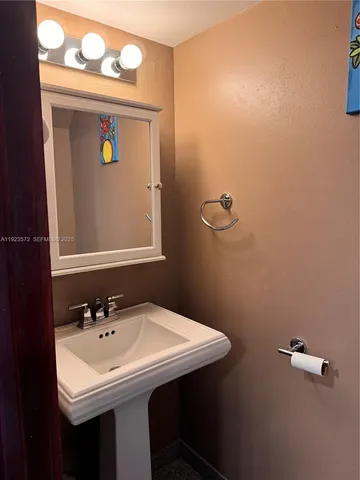 a bathroom with a sink and mirror