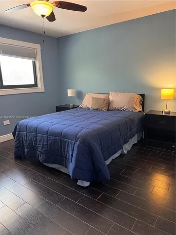 a bedroom with a bed and a lamp with window