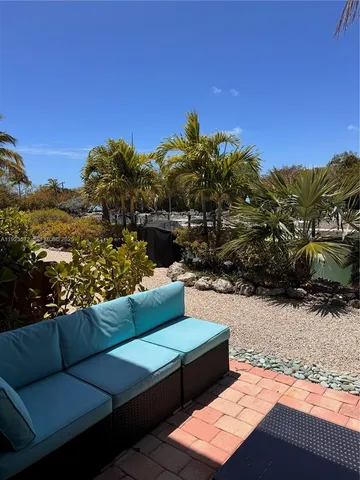 a view of a terrace with couches and sky view