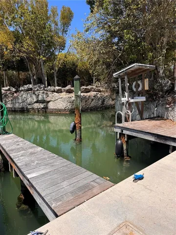 a view of swimming pool with chairs and lake view