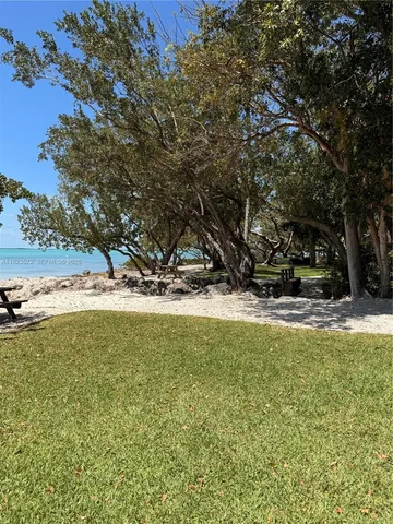 a view of yard with swimming pool and sitting area