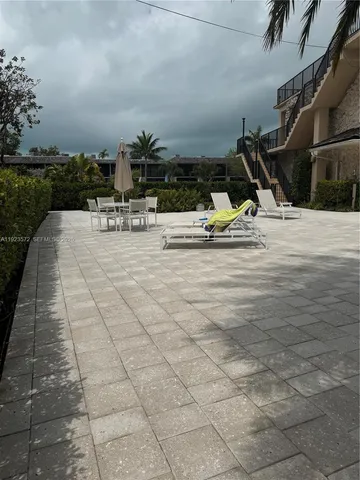 a view of swimming pool with outdoor seating and plants