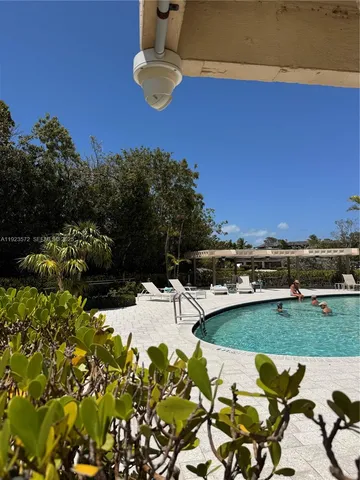 a view of a swimming pool with a yard