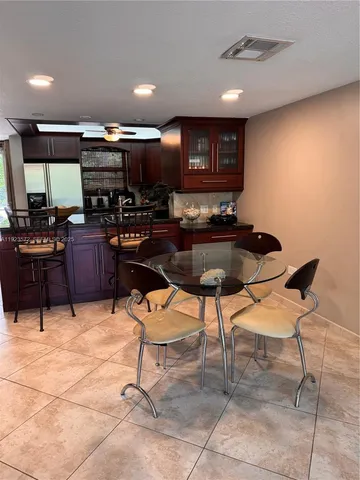 a kitchen with a table and chairs