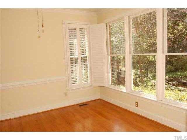 505 Watauga Street Raleigh, NC 27604 - Photo 6 of 10 WALL OF WINDOWS WITH WOOD FLOORS IN DINING ROOM Dining Room