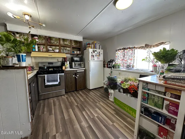 a kitchen with stainless steel appliances granite countertop a stove and a refrigerator