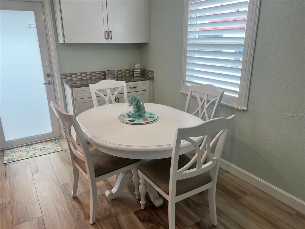 6154 Midnight Pass Road, Unit D16 Sarasota, FL 34242 - Photo 2 of 12 a view of a dining room with furniture and wooden floor