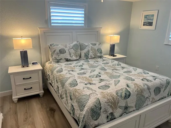 a bedroom with a bed and a lamp