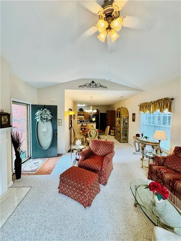 a living room with furniture a rug and a chandelier