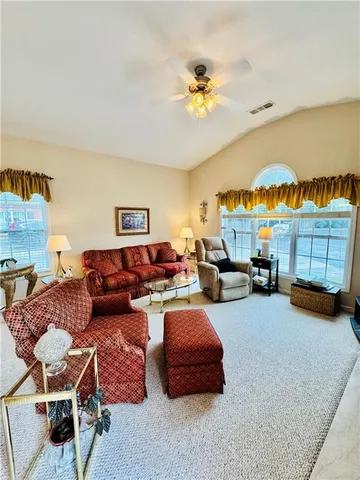 a living room with furniture and a lamp
