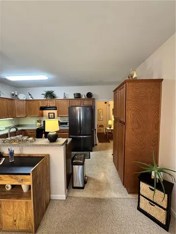 a kitchen with refrigerator and microwave