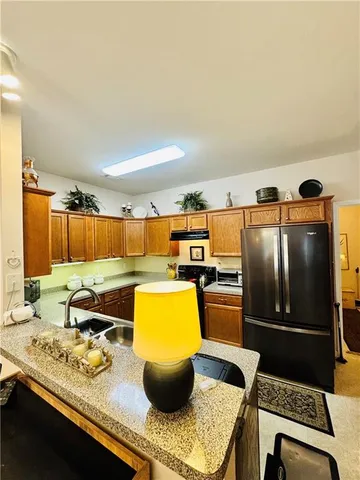 a kitchen with a sink and a stove top oven