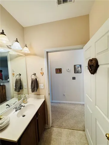 a bathroom with a sink vanity and mirror